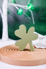 Set of 3 Decorative Wooden Clover Blocks with light green clover block displayed on round wooden tray with blurred background