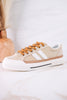 That's Her Tan Tweed Sneakers with white stripes and brown laces displayed on a light marble surface with a wooden vase behind