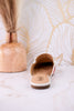 Tip Included Floral Pointed Toe Mules shown from back on marble surface with decorative wooden vase in relaxed setting