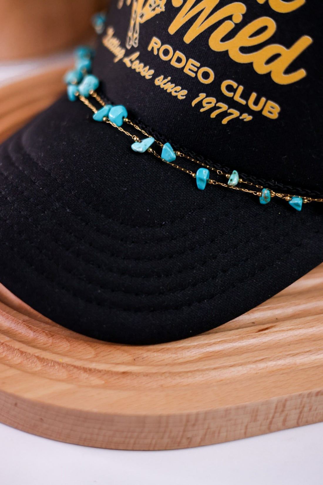 Turquoise Trucker Hat Chain with irregular turquoise stones on delicate gold chain displayed on black cap brim