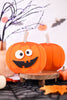 Halloween-themed decorations with pumpkins and decorative branches on a white background.