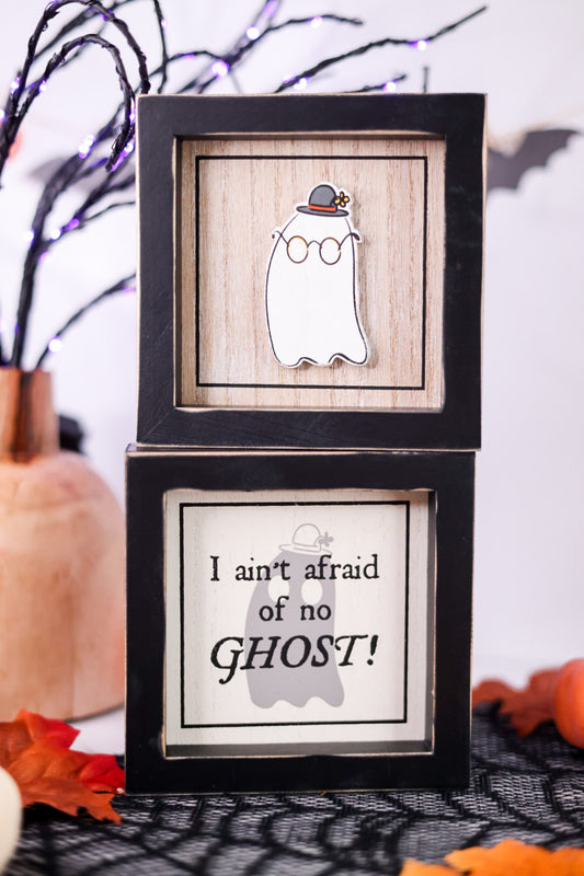Halloween-themed framed picture with ghost design and text on a decorative background.