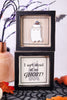 Halloween-themed framed picture with ghost design and text on a decorative background.