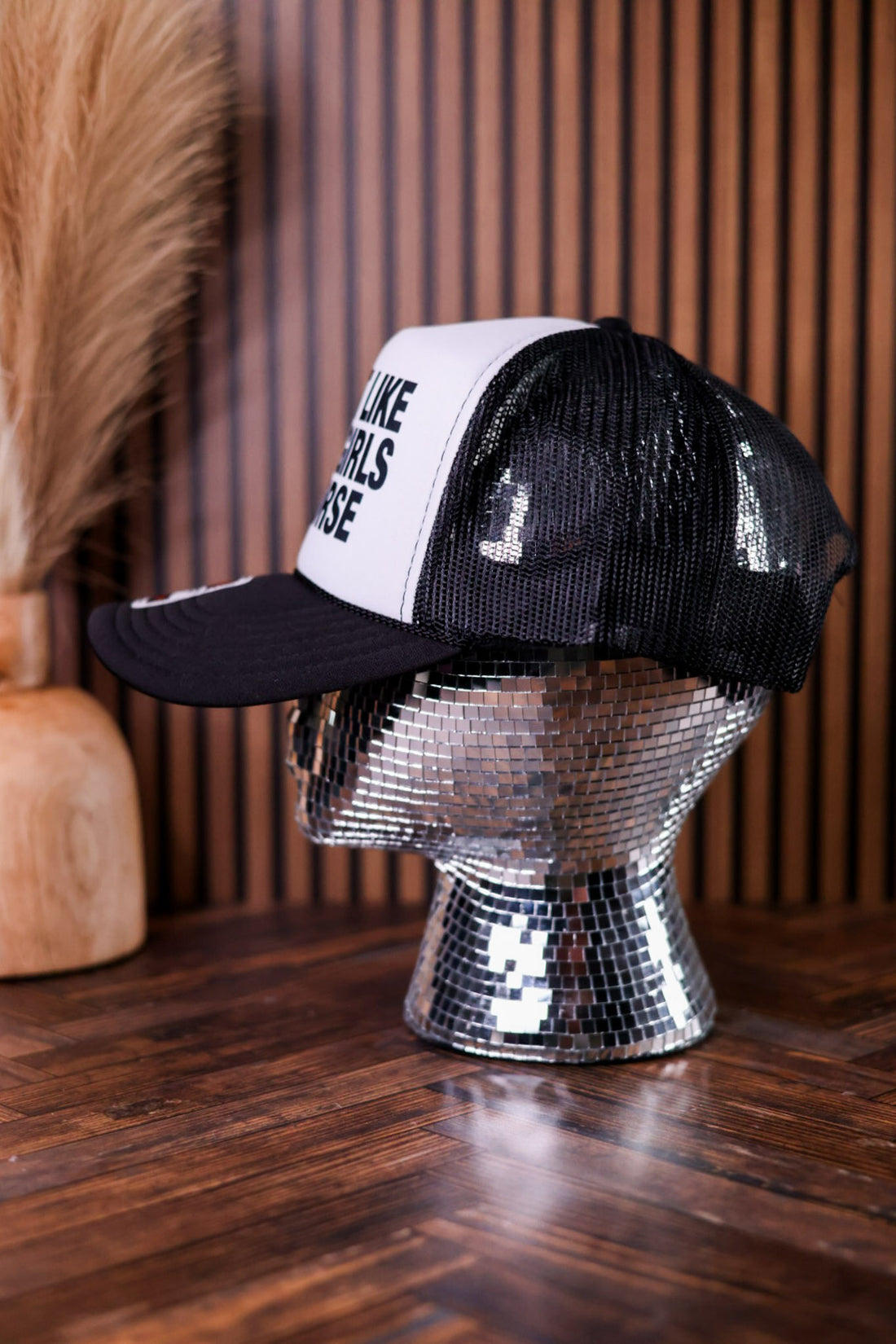 Black & White "I'm Not Like Other Girls, I'm Worse" Trucker Hat displayed on reflective mosaic head form indoors