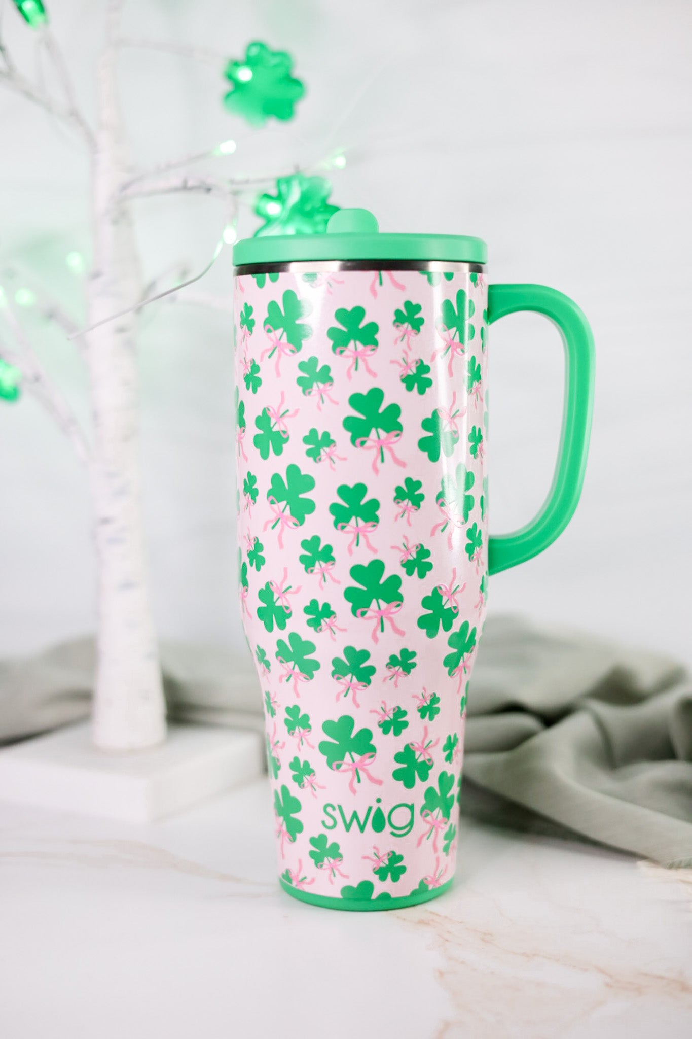 Clover Crush 40oz Mega Mug with bright green handle and lid decorated with various green shamrocks on pink background