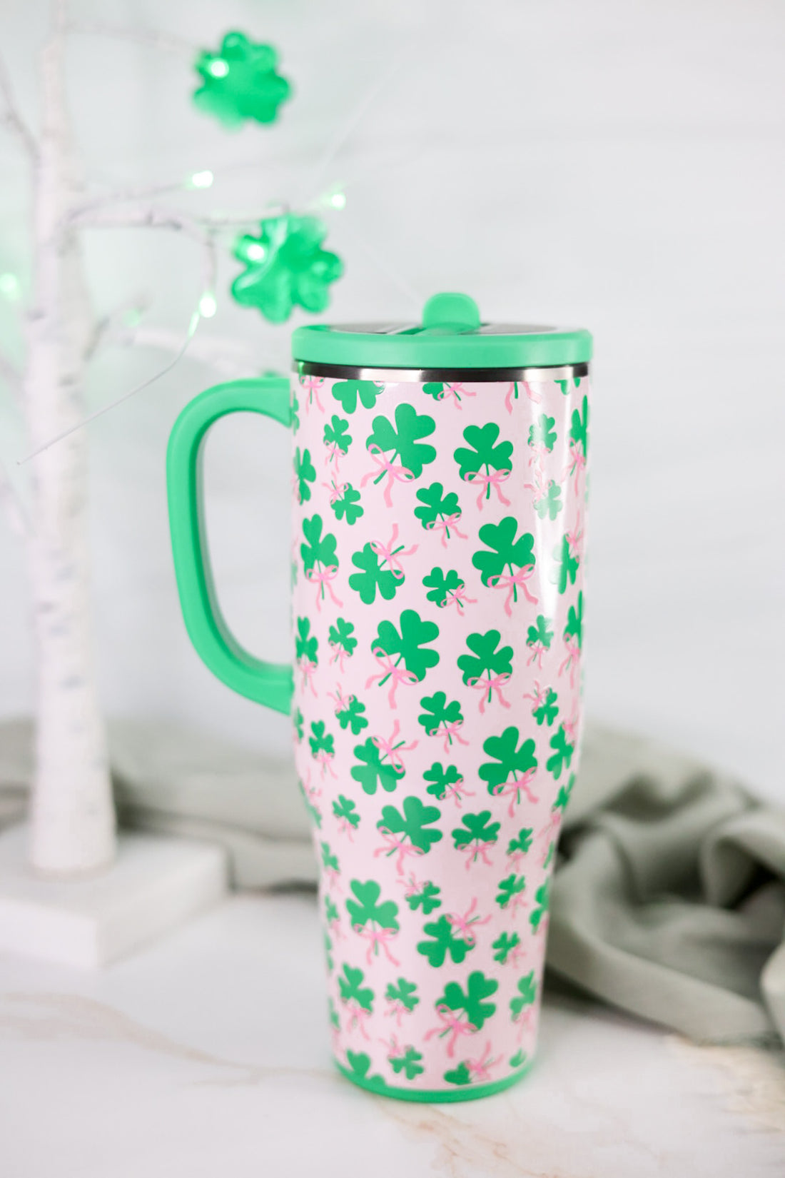 Clover Crush 40oz Mega Mug with green lid and handle featuring green shamrocks with pink bows on pink background