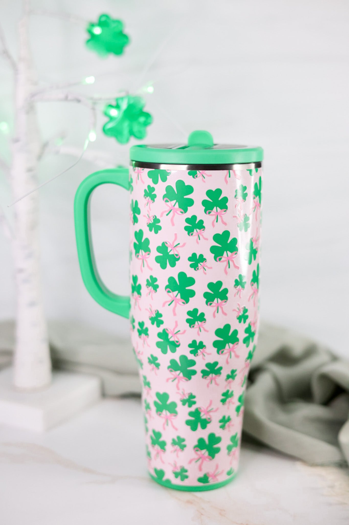 Clover Crush 40oz Mega Mug with green lid and handle featuring green shamrocks with pink bows on pink background