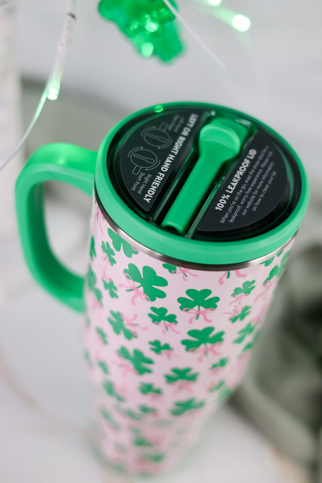 Clover Crush 40oz Mega Mug with green shamrock pattern and green handle on white surface close-up view
