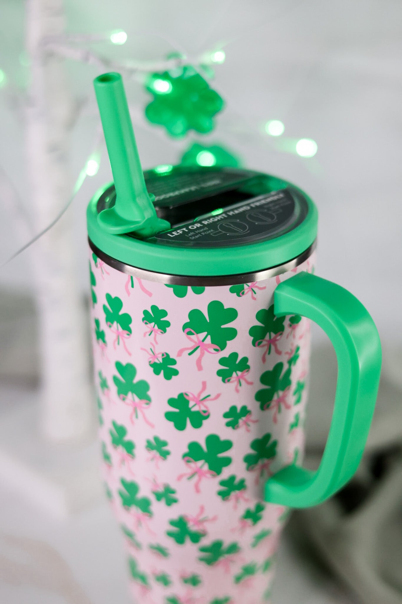 Clover Crush 40oz Mega Mug with bright green handle and lid featuring green shamrocks and pink bows on light background