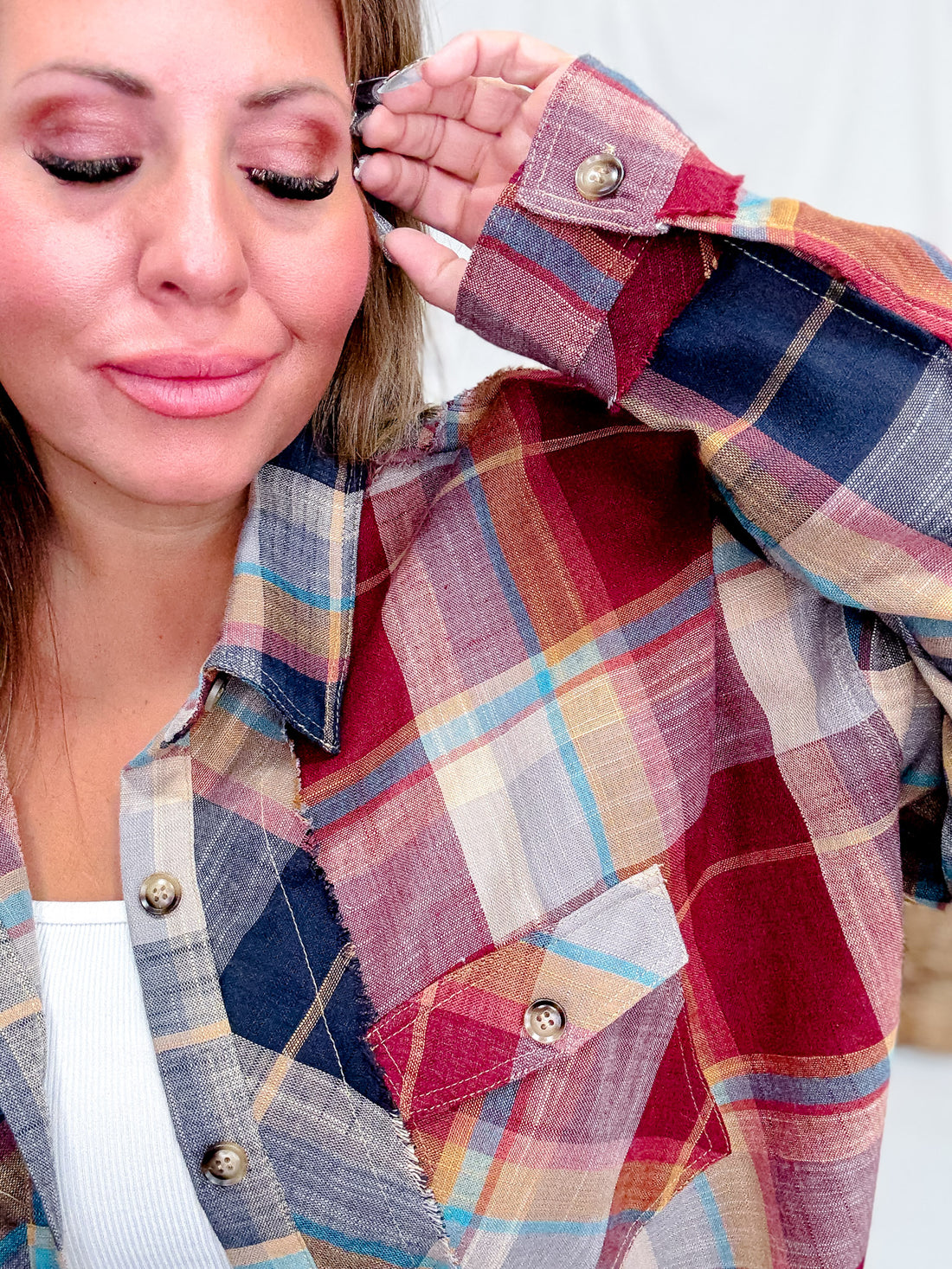 Close-up of woman wearing Wine & Navy Plaid Button Down Flannel With Shirred Sleeves highlighting fabric texture and button details