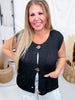 Smiling woman wearing Black Sleeveless Crochet Sweater Vest With Metallic Buttons styled with light denim and posing indoors
