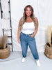 Woman wearing Judy Blue High-Waist Rigid Magic Panel Barrel Jeans styled with white tank top and casual white sneakers for relaxed look