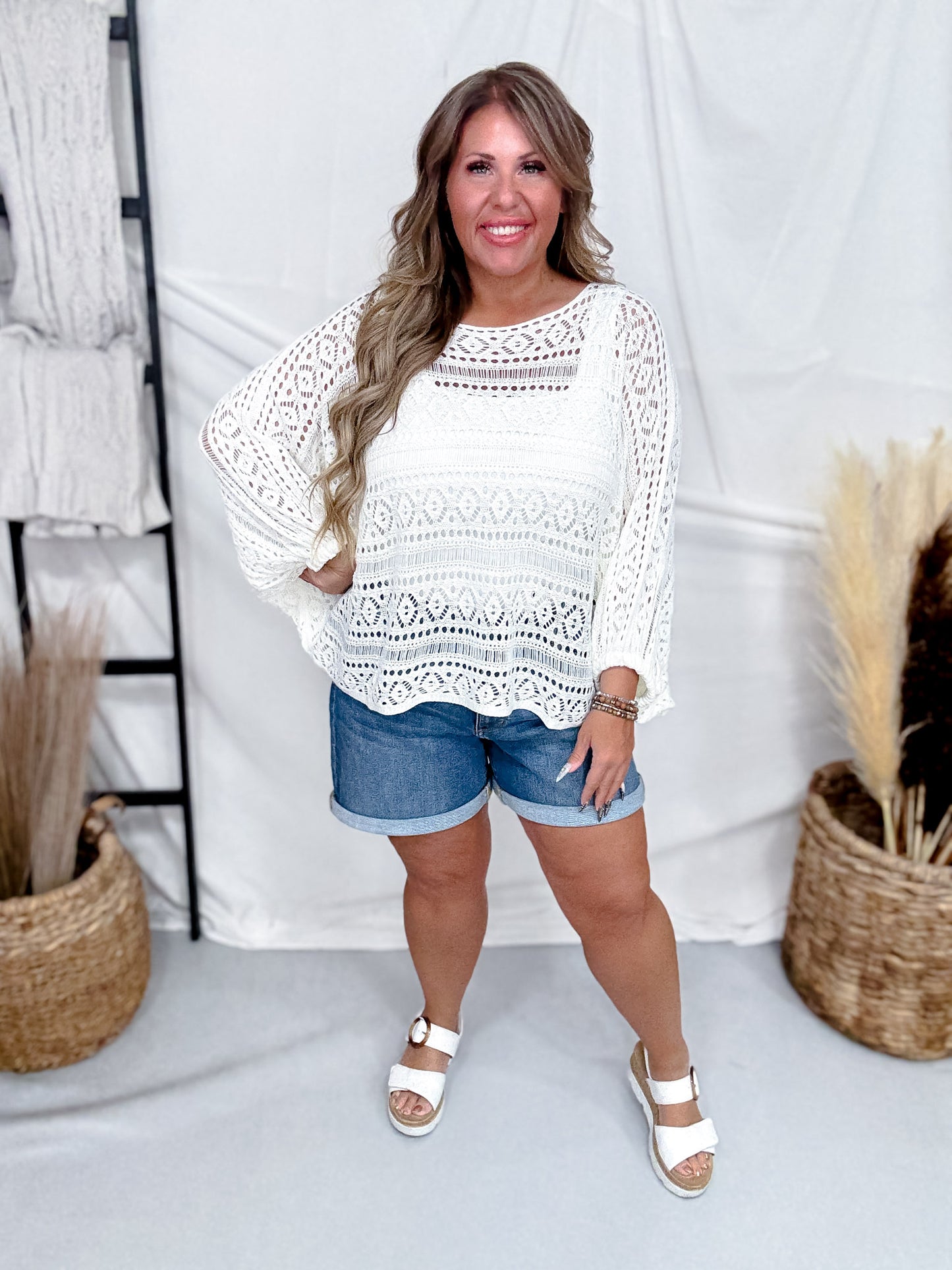 White Open Knit Cover Up With Dolman Sleeves styled with casual denim shorts and white sandals for comfortable summer look